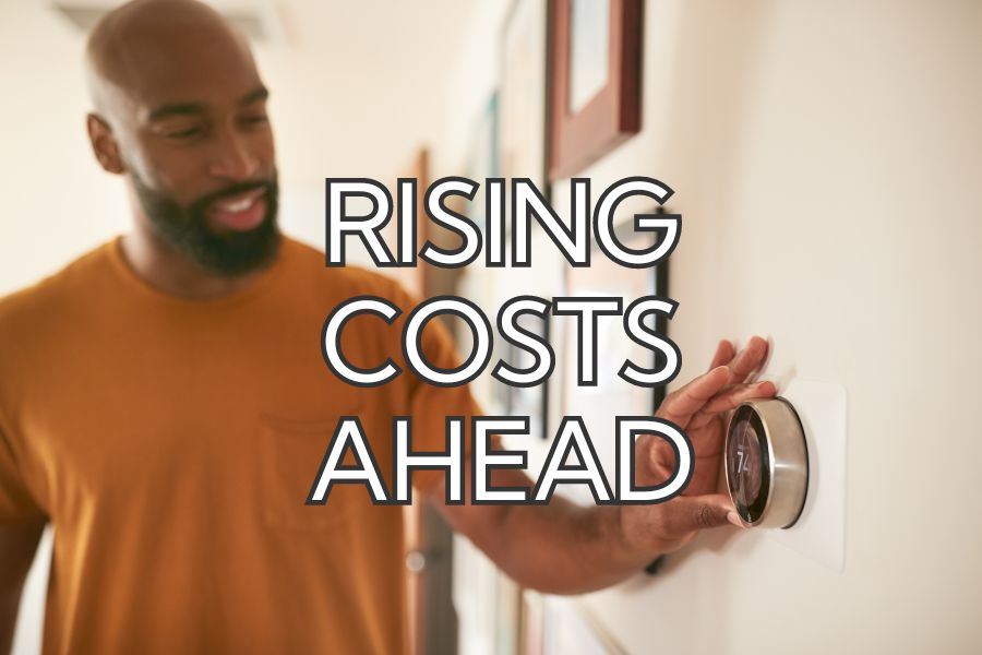 A man adjusting his thermostat with the words "rising costs ahead"